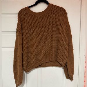 a brown sweater